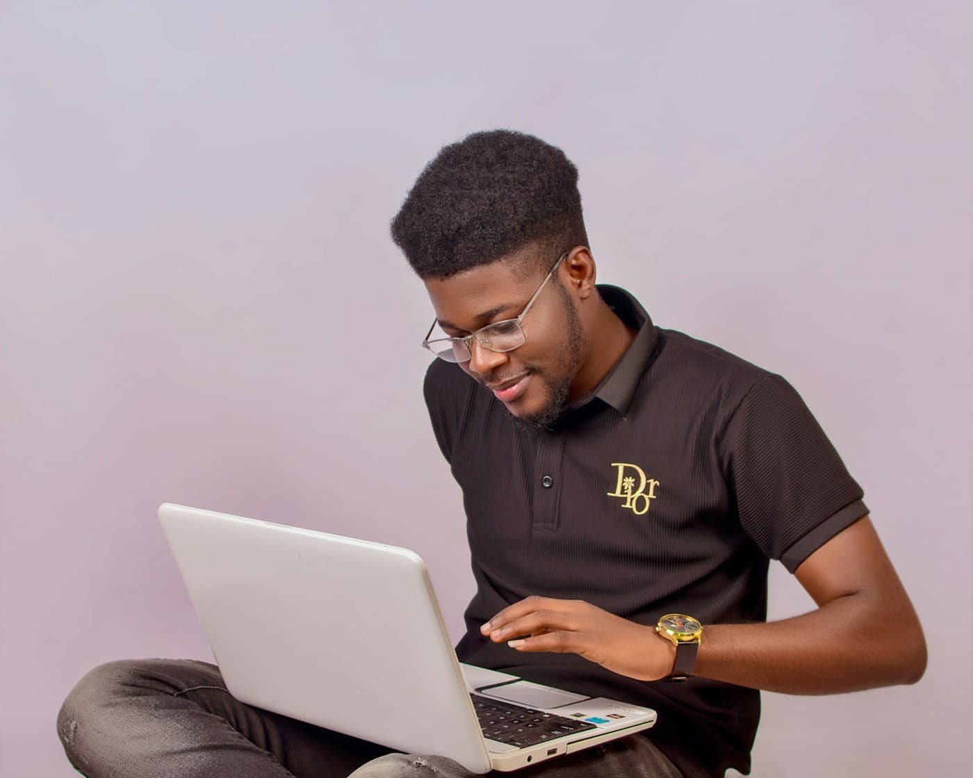 African founder coding on the floor with a laptop, product still unbuilt