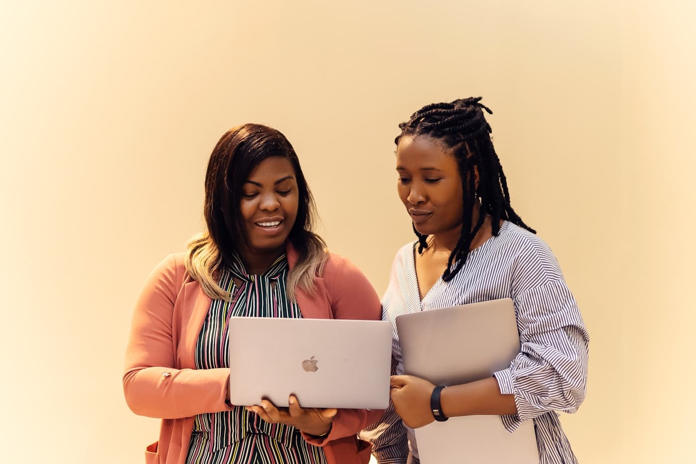 Two African collaborators reviewing a laptop together