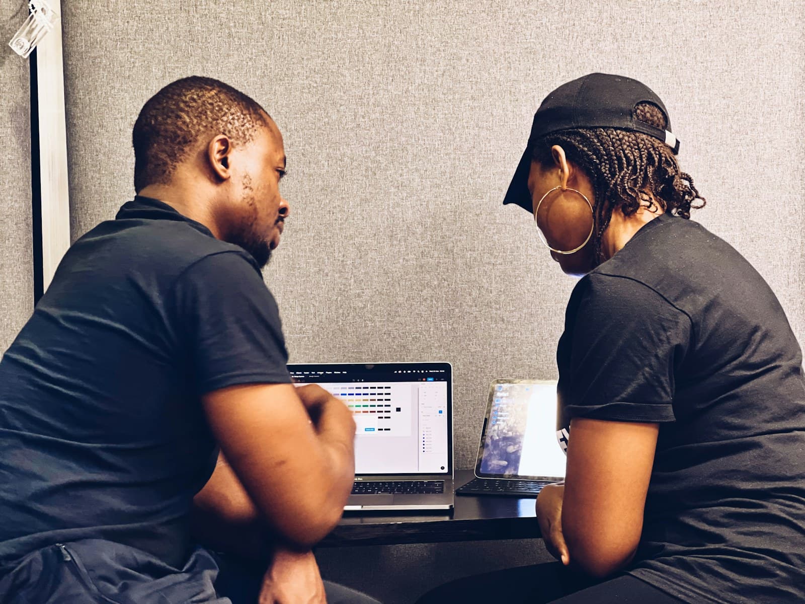 Two African founders reviewing a laptop together to get clear